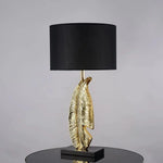 Load image into Gallery viewer, Cayo Table Lamp – Gold Feather &amp; Black Marble, Luxurious Elegance | Chal Decoration

This highlights the lamp’s intricate details, premium materials, and warm, sophisticated ambiance, making it ideal for luxury settings.
