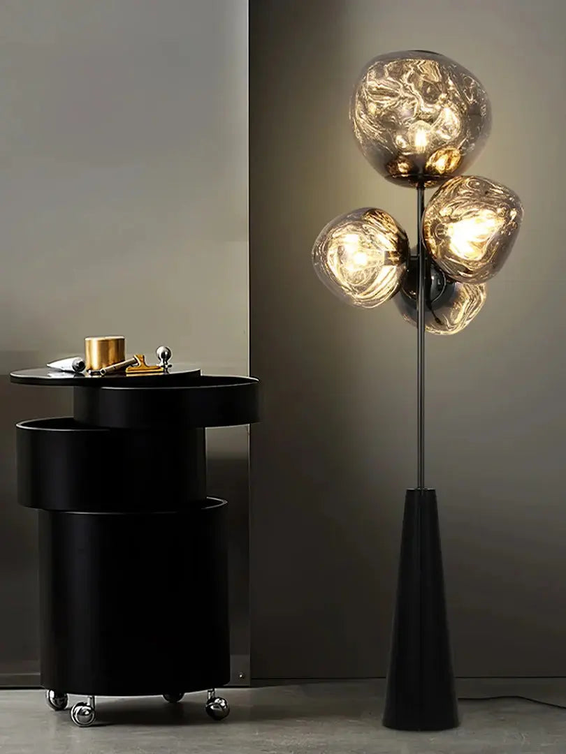 This highlights the lamp’s unique blown glass construction and its modern, optical effect, emphasizing its artistic and sophisticated appeal.