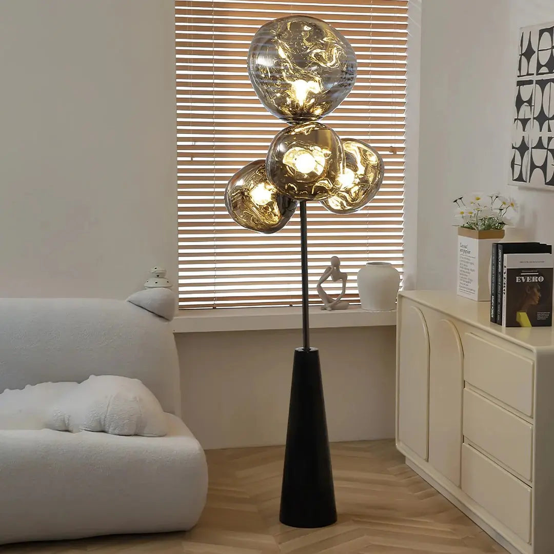 This highlights the lamp’s unique blown glass construction and its modern, optical effect, emphasizing its artistic and sophisticated appeal.