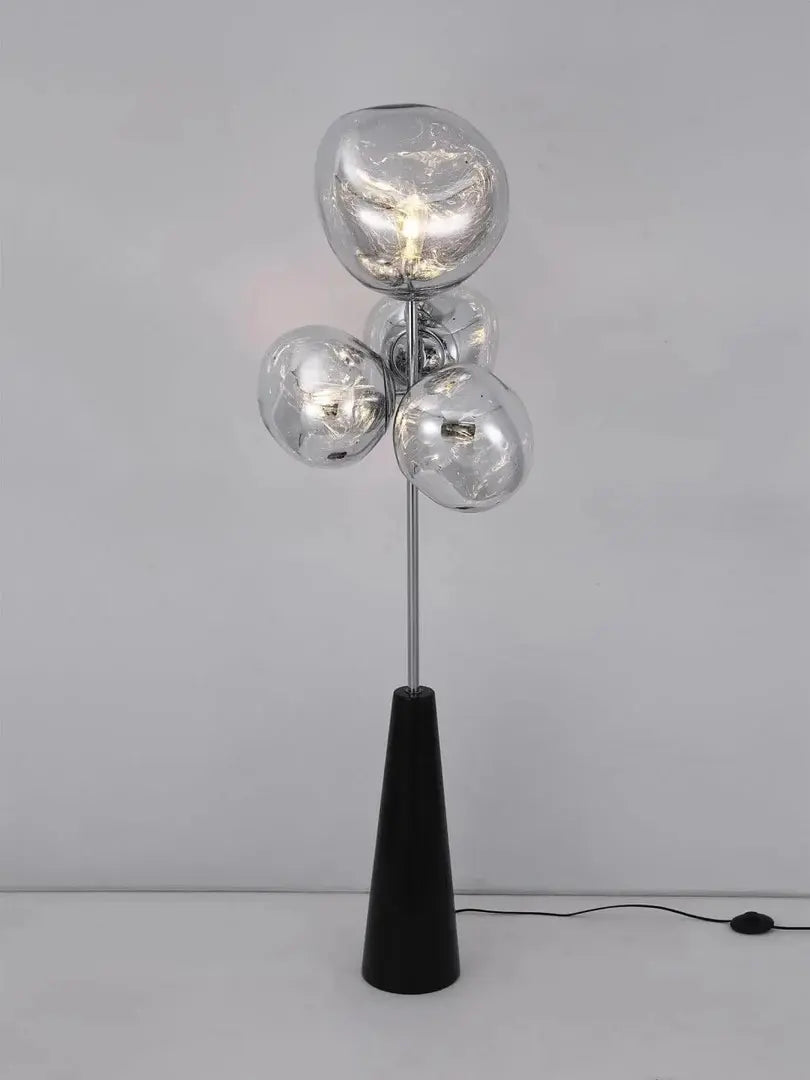 This highlights the lamp’s unique blown glass construction and its modern, optical effect, emphasizing its artistic and sophisticated appeal.