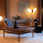 Load image into Gallery viewer, Atollo Metal Table Lamp in black on a side table next to a mid-century modern sofa, complemented by warm ambient lighting, a unique wooden coffee table, and artful decor, creating a sophisticated and inviting living room atmosphere.
