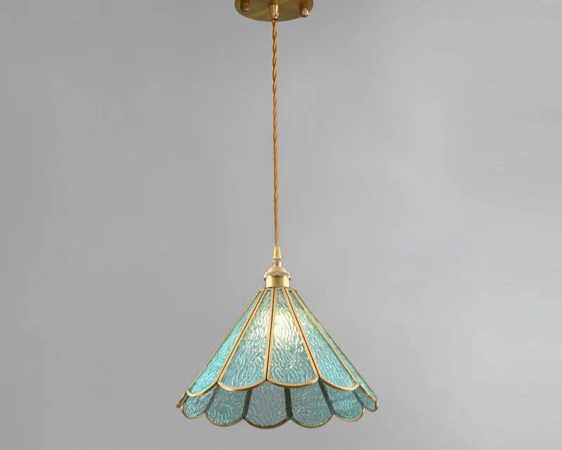 Butterfly pendant lamp with a blue stained glass scalloped shade and gold metal frame, suspended by a twisted cord and brass ceiling mount, adding a vintage and sophisticated ambiance to the decor.