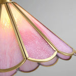 Load image into Gallery viewer, Close-up view of the Butterfly pendant lamp showcasing its pink stained glass panels with a scalloped edge and gold metal trim, highlighting the intricate texture and craftsmanship of the lampshade.
