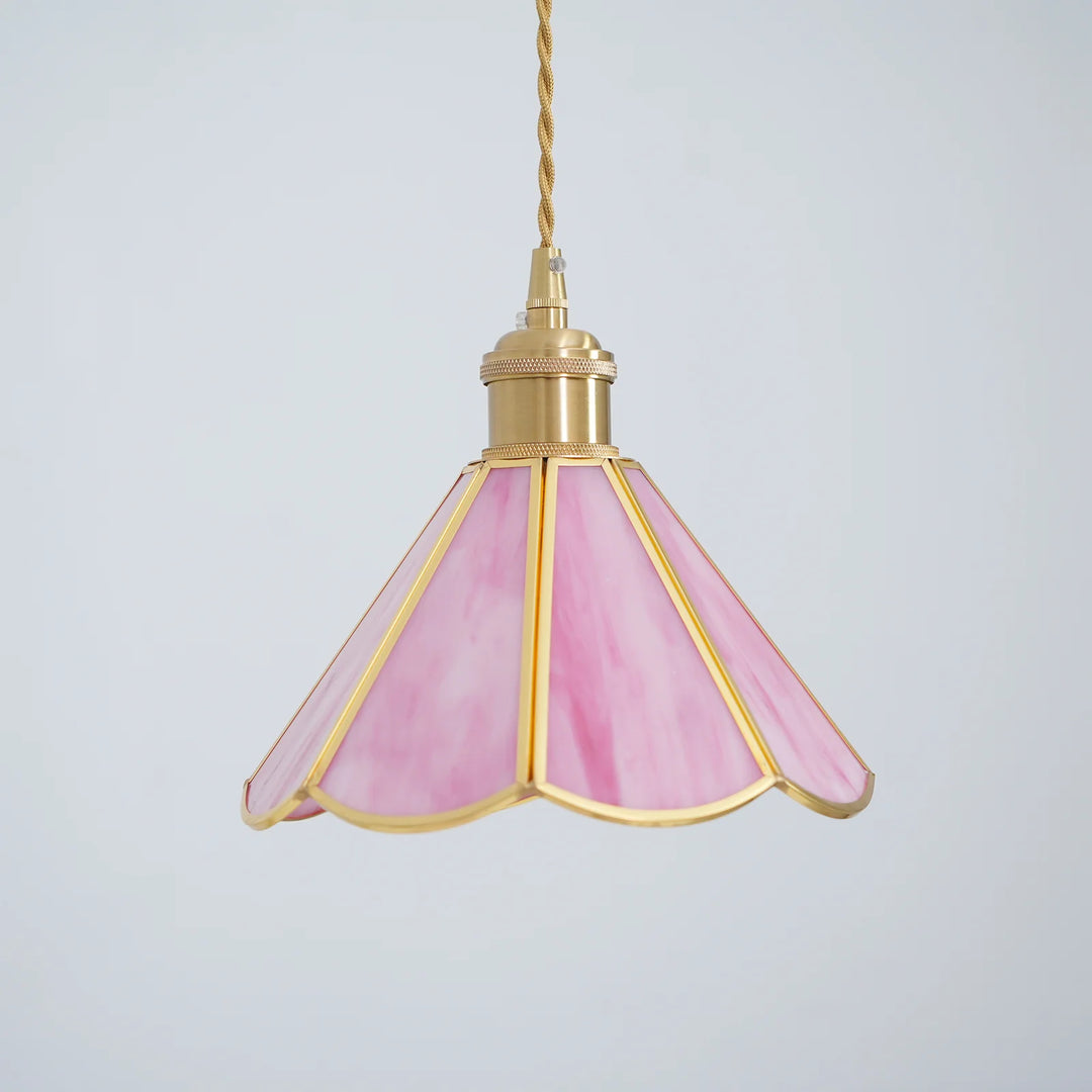 Butterfly pendant lamp with a pink stained glass scalloped shade and gold metal frame, suspended by a twisted cord against a plain white background, highlighting its elegant and timeless design.