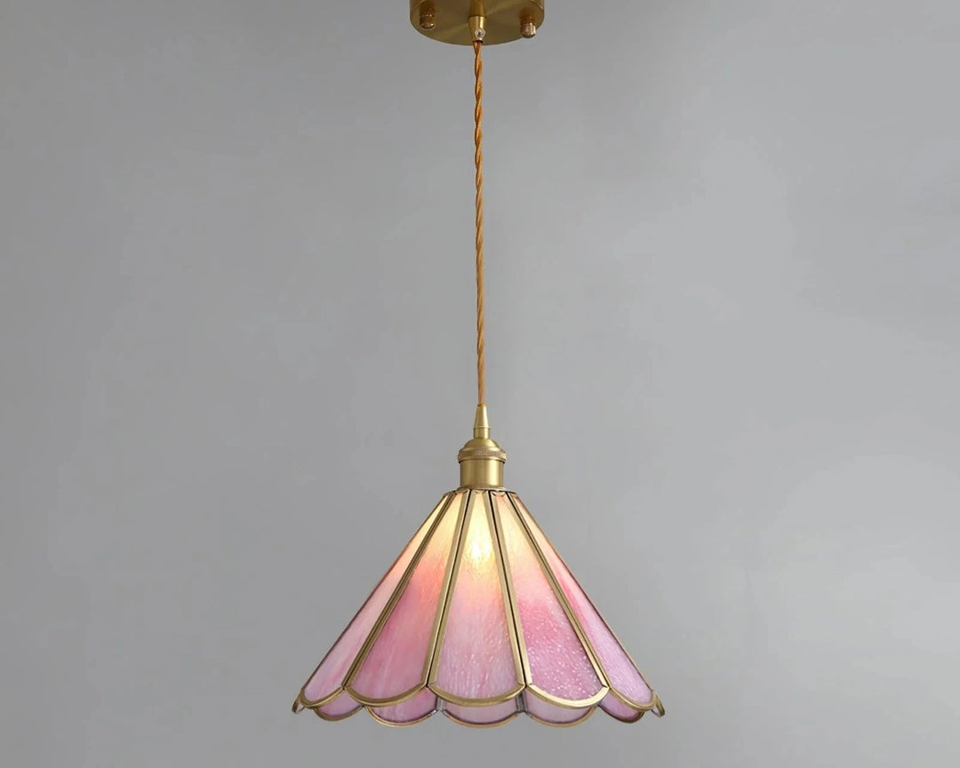 Butterfly pendant lamp with a pink stained glass scalloped shade and gold metal frame, suspended by a twisted cord and brass ceiling mount, adding a vintage and elegant touch to the space.