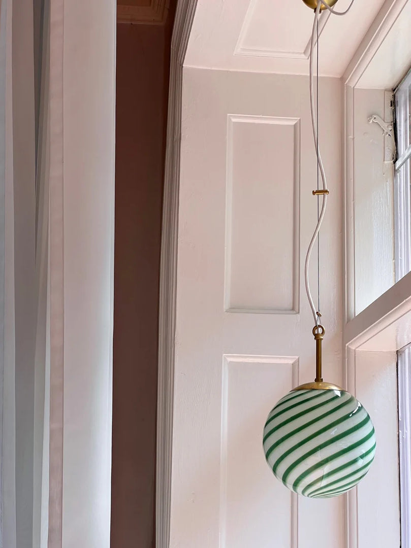 Candy pendant lamp with a vibrant green and white spiral design, bringing playful elegance and a fresh look to any space.