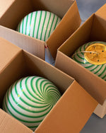 Load image into Gallery viewer, Candy pendant lamp with green and white swirl design, carefully packed in a box, ready for installation, with a modern touch that adds a playful and elegant vibe to any space.
