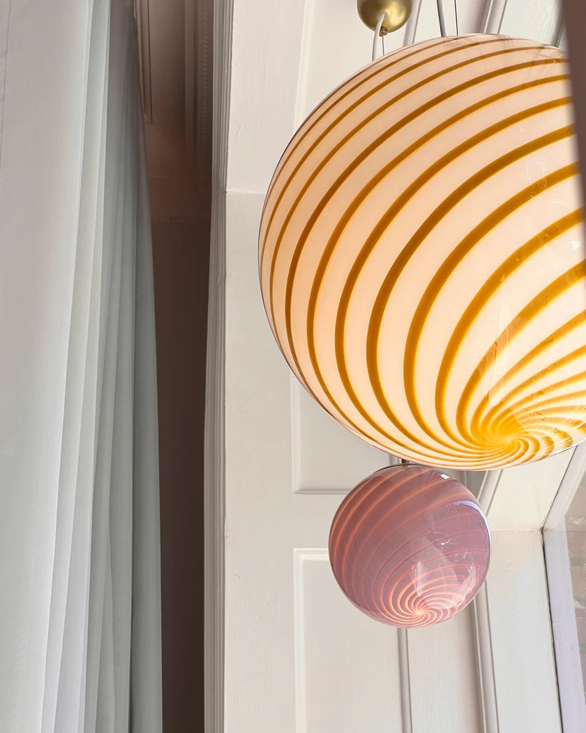 Candy pendant lamp with pink and orange swirl design, creating a charming focal point in any room with its vibrant, playful aesthetic, offering a unique touch to the space.