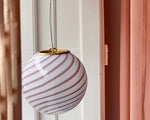 Load image into Gallery viewer, Candy pendant lamp featuring a soft pink and white striped globe-shaped glass shade with a sleek gold rim, suspended near soft pink curtains, adding a chic and contemporary touch to the room.
