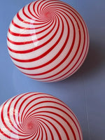 Load image into Gallery viewer, This Candy pendant lamp, featuring a bold red and white striped swirl pattern, adds a playful yet sophisticated charm to the space, creating an eye-catching focal point overhead.
