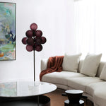 Load image into Gallery viewer, The Cépage Floor Lamp with burgundy globe-shaped lights on a black stand, placed in a bright living room featuring a white curved sectional sofa, a cozy rust-colored throw blanket, a round marble coffee table, and an abstract colorful wall painting for a modern artistic touch.
