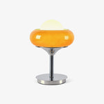 Load image into Gallery viewer, Front-facing product shot of the Crostata Table Lamp featuring a glowing white orb encased in a bold orange glass bowl with a polished chrome base, isolated on a clean white background for a minimalist presentation.
