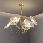 Load image into Gallery viewer, A stunning crystal floral chandelier with delicately crafted clear petal-shaped shades and a golden frame, casting a soft, ambient glow. Its graceful curves and luxurious details add a touch of sophistication to the room, perfect for enhancing contemporary or classic interiors.
