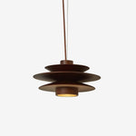 Load image into Gallery viewer, Cylindrical Pendant Light with a layered metal design in a deep brown finish, suspended by a single cord and isolated against a clean white background, showcasing its sleek profile and warm downlight effect.
