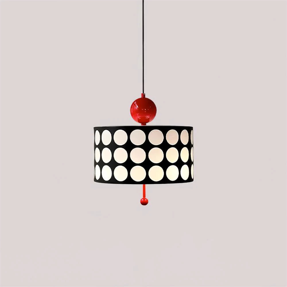 A sleek Metal Lattice Pendant Lamp featuring a striking black shade adorned with white circles, accented with red connectors, creating a bold and contemporary visual against a neutral backdrop.