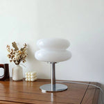 Load image into Gallery viewer, Modern Glossy Macaron Table Lamp in a home setting with decorative dried flowers and stylish ornaments, enhancing the contemporary interior decor.
