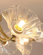 Load image into Gallery viewer, A close-up view of the Kalin Flower Glass Ceiling Light showcasing the intricate petal-shaped glass shade that beautifully diffuses the light from an exposed filament bulb. The textured glass petals and brushed gold fixture add a touch of elegance and sophistication, enhancing the warm glow and floral-inspired aesthetic of this stunning decor piece.
