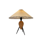 Load image into Gallery viewer, A Makie Table Lamp featuring a pleated fabric shade with black stitching, supported by a wooden base and black tripod legs.
