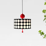 Load image into Gallery viewer, Simplistic yet striking Metal Lattice Pendant Lamp with black and white circular patterns and a bold red fixture, displayed against a crisp white background with a hint of green foliage, offering a clean and modern aesthetic.
