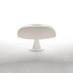 Load image into Gallery viewer, A sleek Mushroom Playful Table Lamp in pure white stands out with its smooth, simple silhouette against a stark white background, embodying minimalist elegance and modern design in a serene and uncluttered setting.
