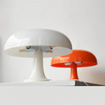 Load image into Gallery viewer, Cream and orange Mushroom Playful Table Lamps juxtaposed to highlight their glossy finishes and curvaceous designs, the two tones playing off each other to enhance the visual appeal in a minimalist setting, perfect for modern interiors.
