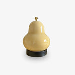 Load image into Gallery viewer, Minimalist pear-shaped table lamp with a glossy yellow finish and black base, placed against a plain white background showcasing its modern design.
