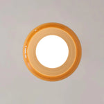 Load image into Gallery viewer, A bottom view of the Sanna cylinder ceiling light showcasing its circular amber shade and bright central illumination, highlighting its sleek and modern design.
