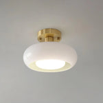 Load image into Gallery viewer, A sleek Sanna cylinder ceiling light with a white glass shade and a brushed brass mount, offering soft and elegant illumination suitable for modern interiors.
