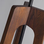 Load image into Gallery viewer, A close-up view of the wooden tripod base of a floor lamp, highlighting the natural grain texture and craftsmanship of the wood against a neutral background.
